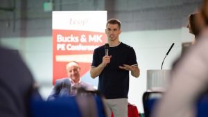 Max Whitlock addressing audience in front of a Leap banner