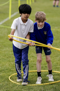 Two children working together with hoop