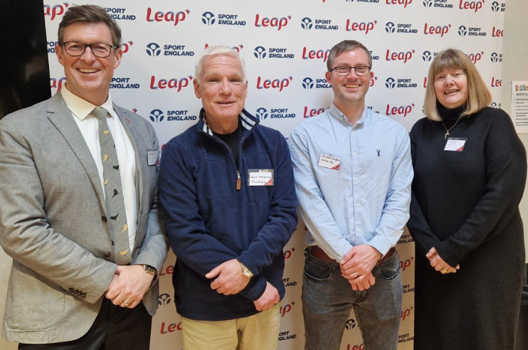 Mark Ormerod, Alan Naismith, Richard Claydon and Sue Imbriano standing in front of a Leap banner