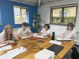 Four young people writing their CVs