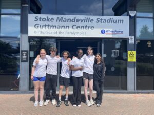 Group of six young people outside Stoke Mandeville Stadium