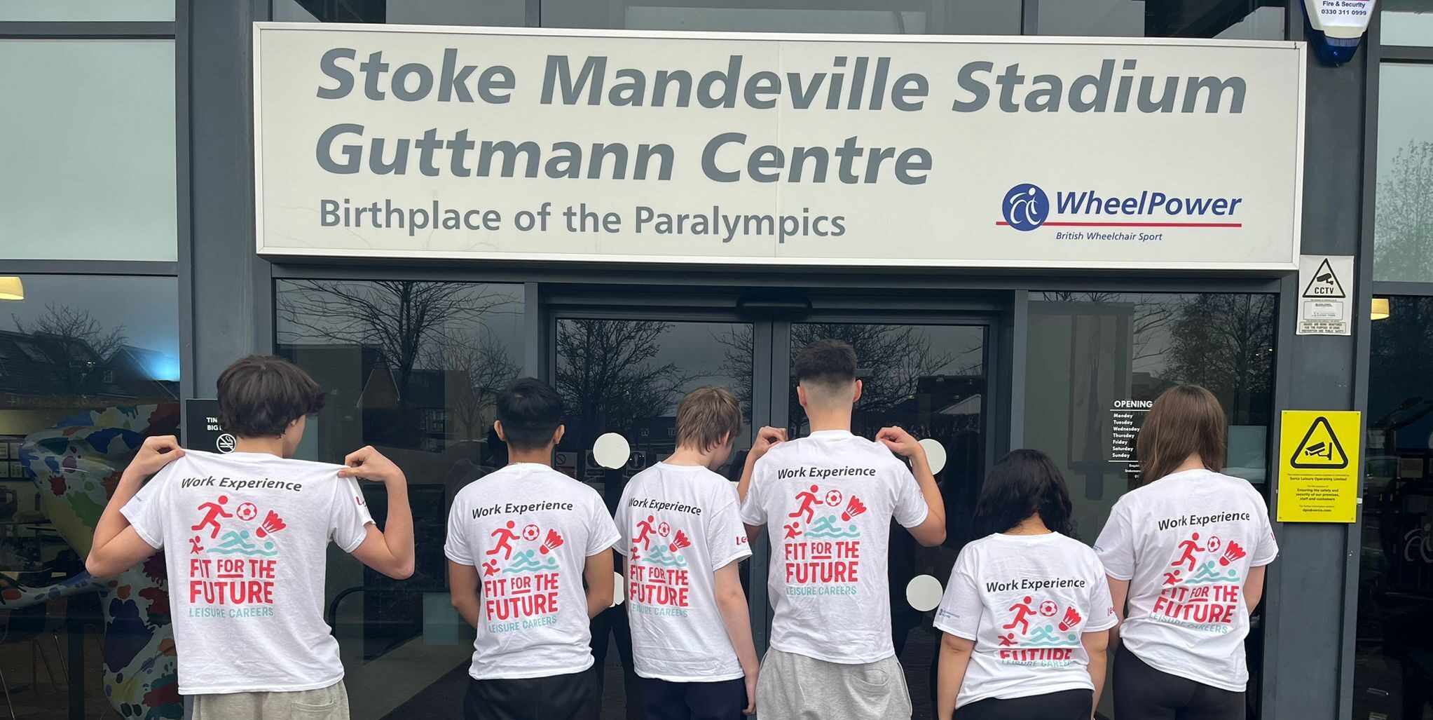Group of six young people outside Stoke Mandeville Stadium with matching ' fit for the future ' t-shirts